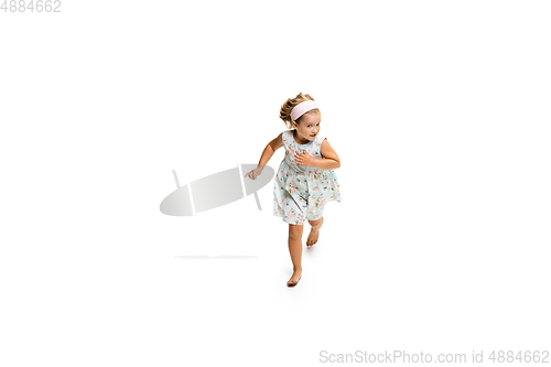 Image of Happy little caucasian girl jumping and running isolated on white background