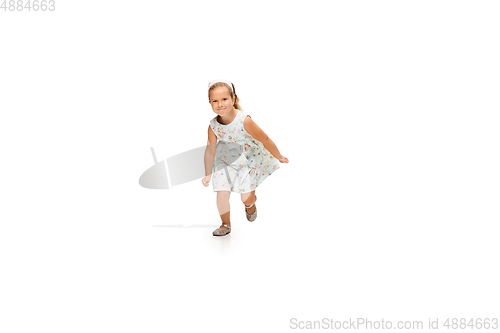 Image of Happy little caucasian girl jumping and running isolated on white background