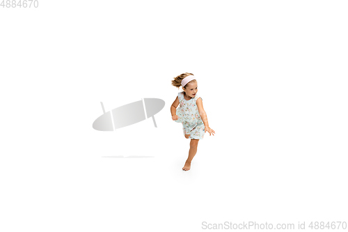 Image of Happy little caucasian girl jumping and running isolated on white background