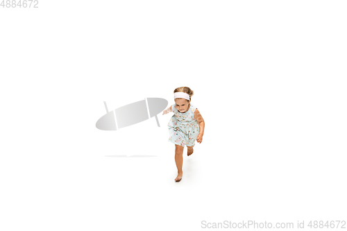 Image of Happy little caucasian girl jumping and running isolated on white background