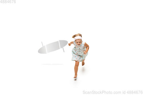 Image of Happy little caucasian girl jumping and running isolated on white background