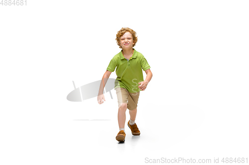 Image of Happy little caucasian boy jumping and running isolated on white background