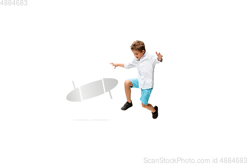 Image of Happy little caucasian boy jumping and running isolated on white background