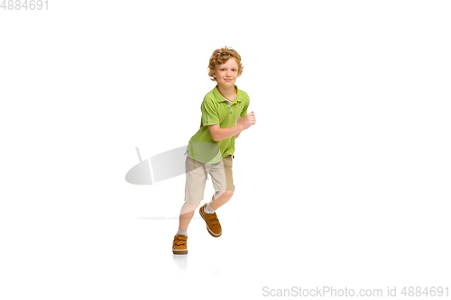 Image of Happy little caucasian boy jumping and running isolated on white background