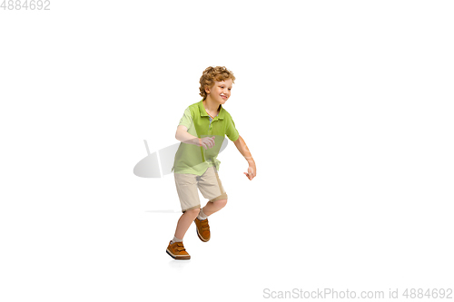 Image of Happy little caucasian boy jumping and running isolated on white background