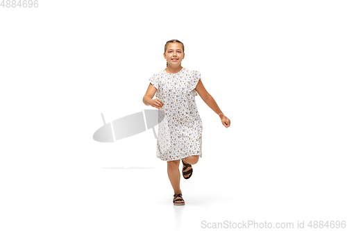 Image of Happy little caucasian girl jumping and running isolated on white background