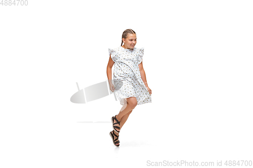 Image of Happy little caucasian girl jumping and running isolated on white background