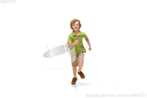 Image of Happy little caucasian boy jumping and running isolated on white background