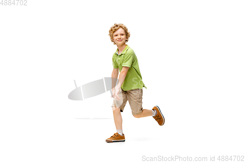 Image of Happy little caucasian boy jumping and running isolated on white background