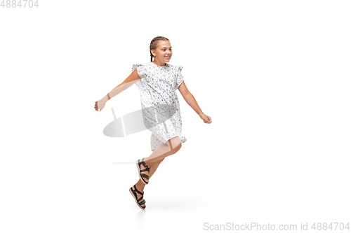 Image of Happy little caucasian girl jumping and running isolated on white background