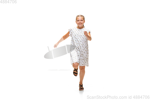 Image of Happy little caucasian girl jumping and running isolated on white background