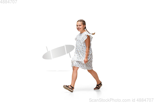Image of Happy little caucasian girl jumping and running isolated on white background
