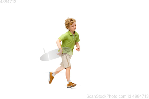 Image of Happy little caucasian boy jumping and running isolated on white background