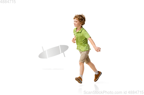 Image of Happy little caucasian boy jumping and running isolated on white background