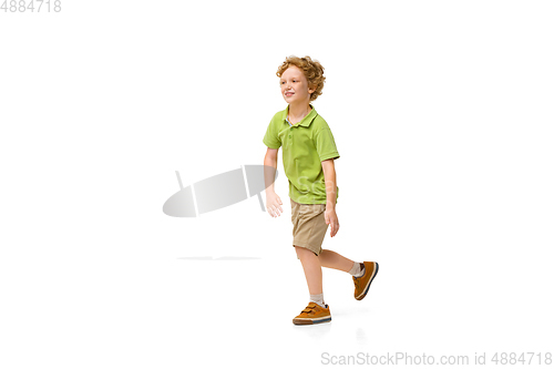Image of Happy little caucasian boy jumping and running isolated on white background