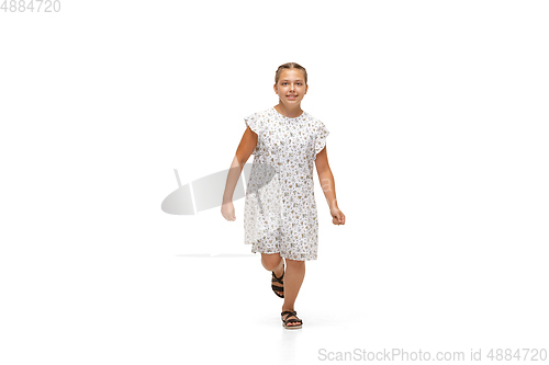 Image of Happy little caucasian girl jumping and running isolated on white background