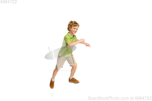 Image of Happy little caucasian boy jumping and running isolated on white background