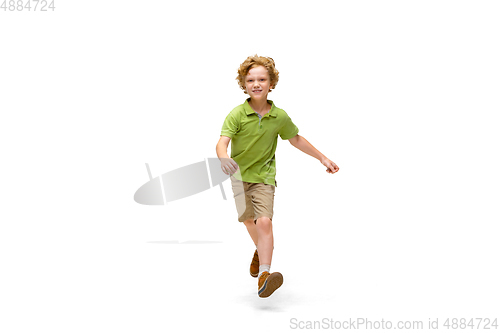 Image of Happy little caucasian boy jumping and running isolated on white background