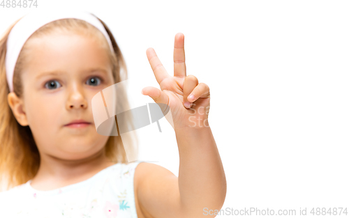 Image of Little girl gesturing isolated on white studio background with copyspace