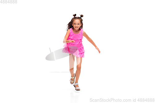 Image of Happy little caucasian girl jumping and running isolated on white background