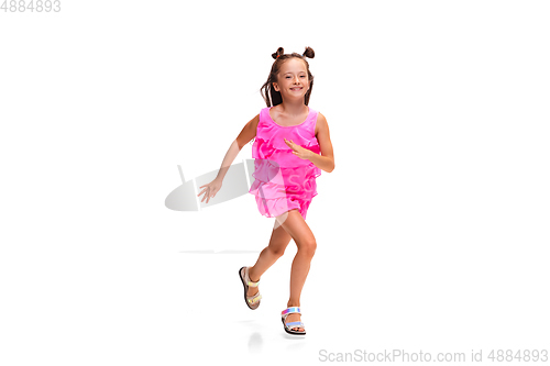 Image of Happy little caucasian girl jumping and running isolated on white background