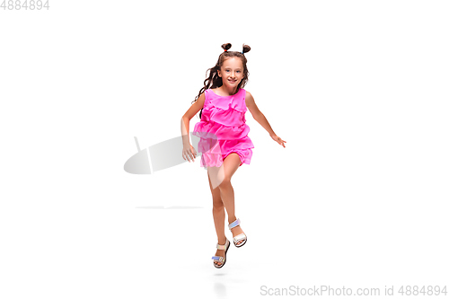 Image of Happy little caucasian girl jumping and running isolated on white background