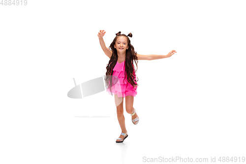 Image of Happy little caucasian girl jumping and running isolated on white background