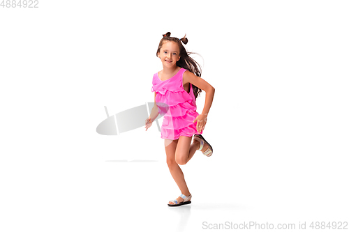 Image of Happy little caucasian girl jumping and running isolated on white background