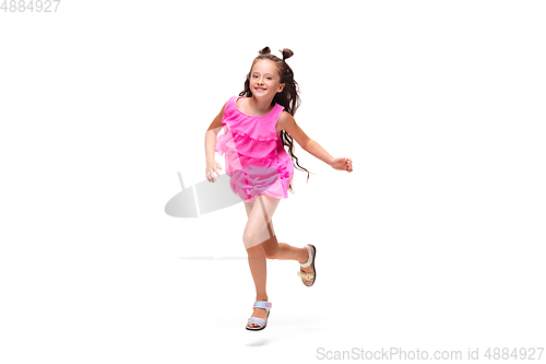 Image of Happy little caucasian girl jumping and running isolated on white background