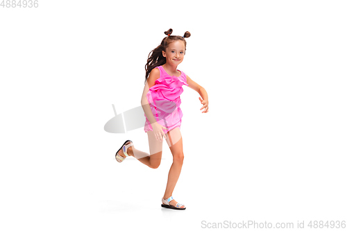 Image of Happy little caucasian girl jumping and running isolated on white background