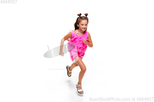 Image of Happy little caucasian girl jumping and running isolated on white background