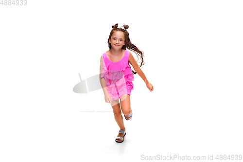 Image of Happy little caucasian girl jumping and running isolated on white background