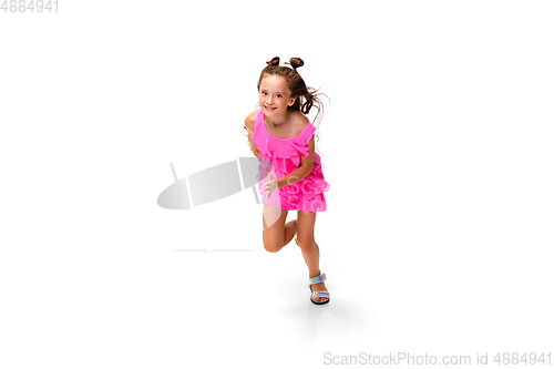 Image of Happy little caucasian girl jumping and running isolated on white background
