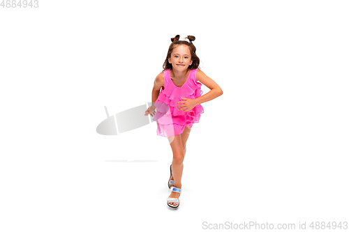 Image of Happy little caucasian girl jumping and running isolated on white background