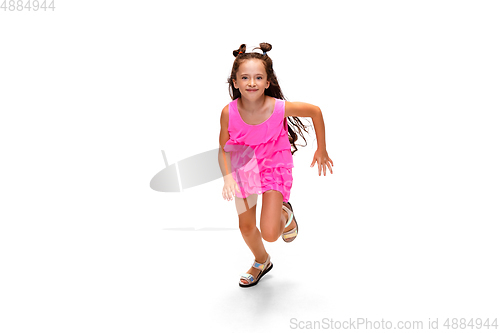 Image of Happy little caucasian girl jumping and running isolated on white background