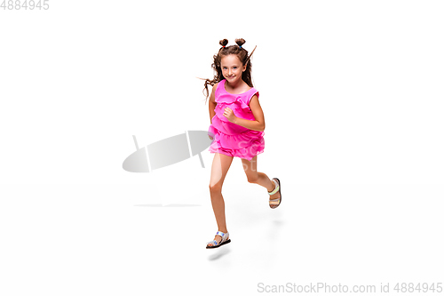 Image of Happy little caucasian girl jumping and running isolated on white background