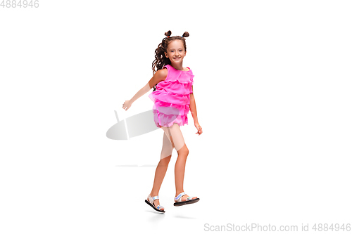 Image of Happy little caucasian girl jumping and running isolated on white background