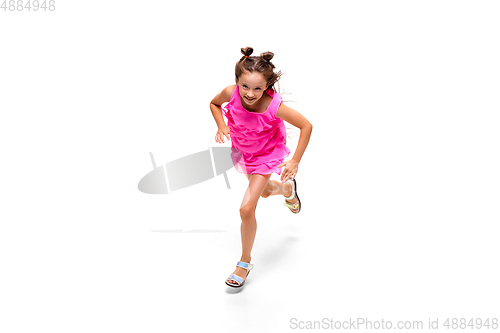 Image of Happy little caucasian girl jumping and running isolated on white background