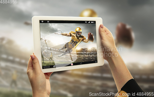 Image of Close up hands holding tablet viewing sport, online translation, streaming of championship