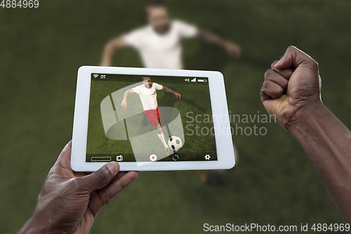 Image of Close up hands holding tablet viewing sport, online translation, streaming of championship