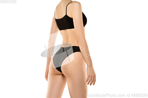Image of Beautiful female body isolated on white background. Sportive, sensual body with well-kept skin in underwear.