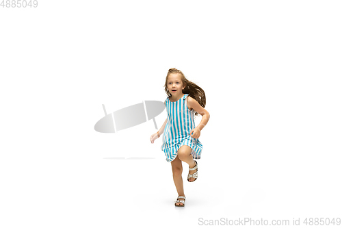 Image of Happy little caucasian girl jumping and running isolated on white background