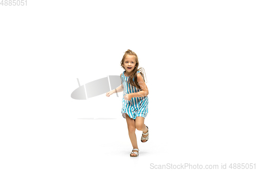 Image of Happy little caucasian girl jumping and running isolated on white background