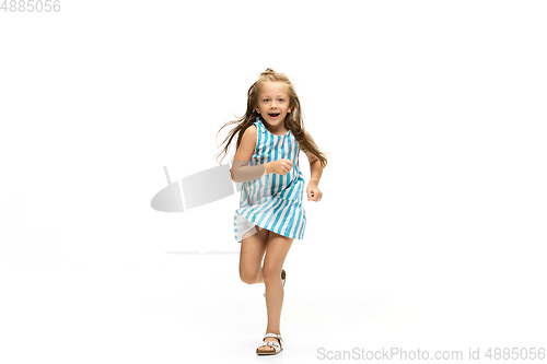 Image of Happy little caucasian girl jumping and running isolated on white background