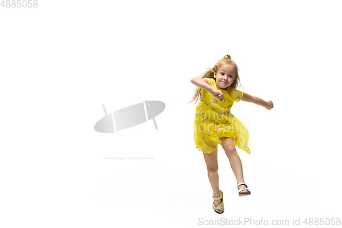 Image of Happy little caucasian girl jumping and running isolated on white background