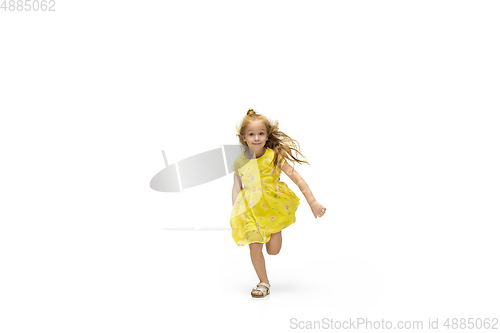 Image of Happy little caucasian girl jumping and running isolated on white background