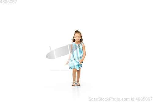 Image of Happy little caucasian girl jumping and running isolated on white background