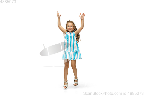 Image of Happy little caucasian girl jumping and running isolated on white background