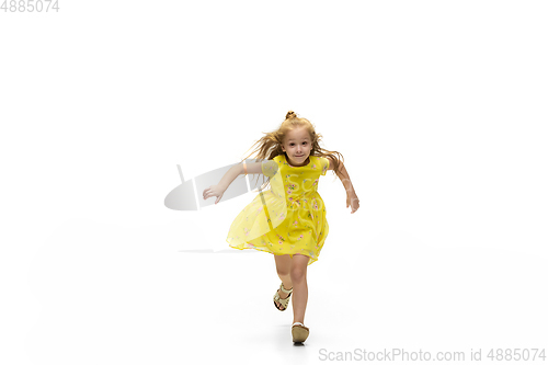 Image of Happy little caucasian girl jumping and running isolated on white background