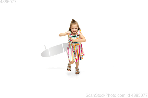Image of Happy little caucasian girl jumping and running isolated on white background